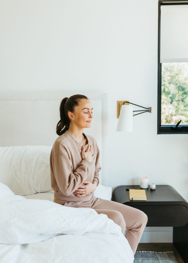 Megan Roup meditating on bed_essential oils for focus