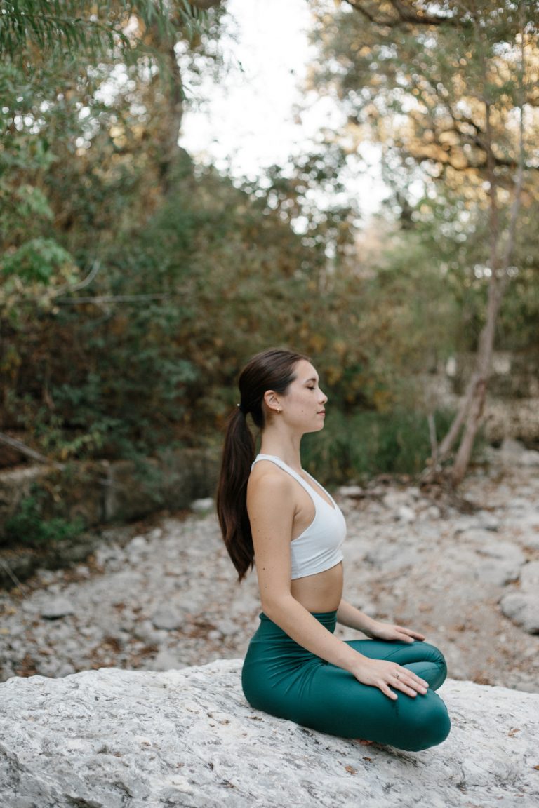 woman sitting on a rock in a sitting position_ birth control and vitamin deficiency