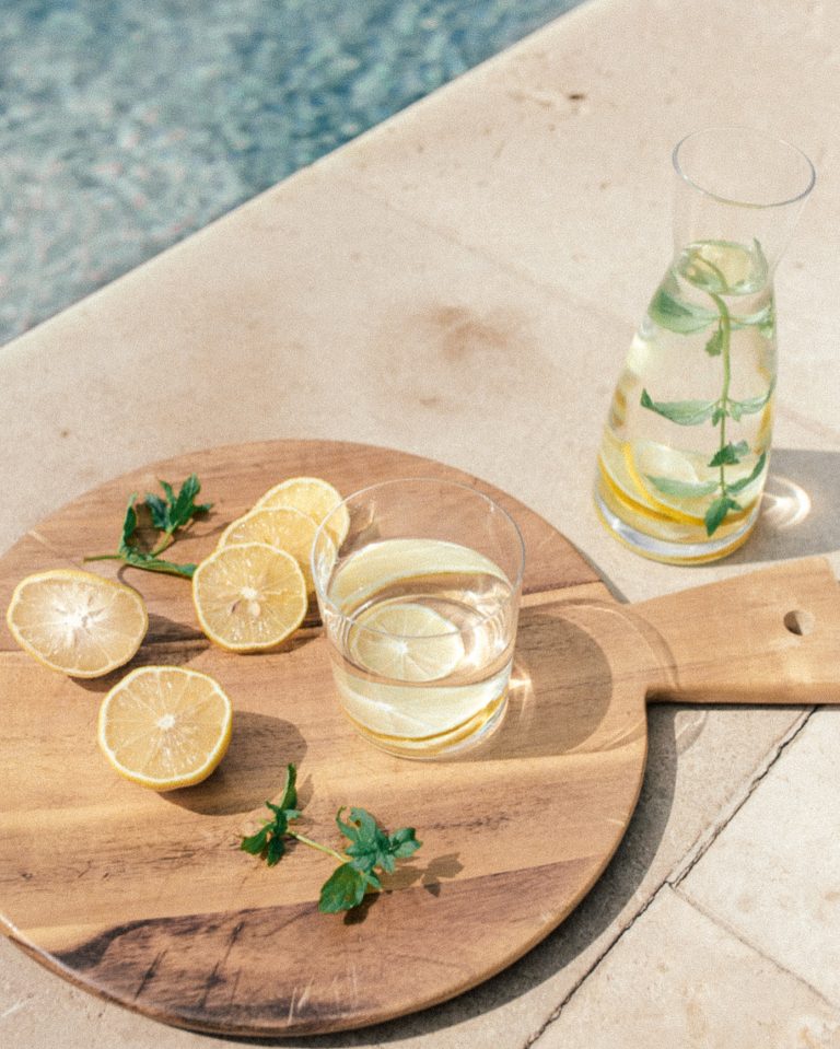 lemon water by pool for hydration_benefits of lemon water in the morning