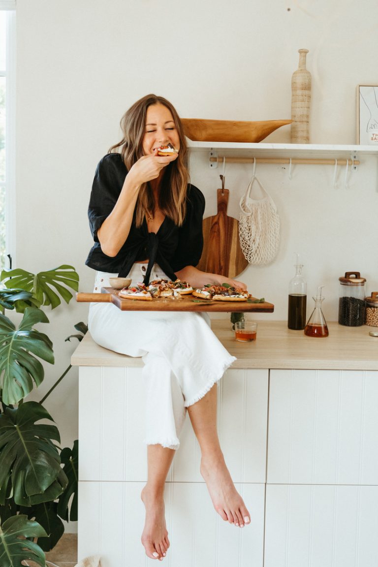 woman eating pizza sitting on counter nutrition myths