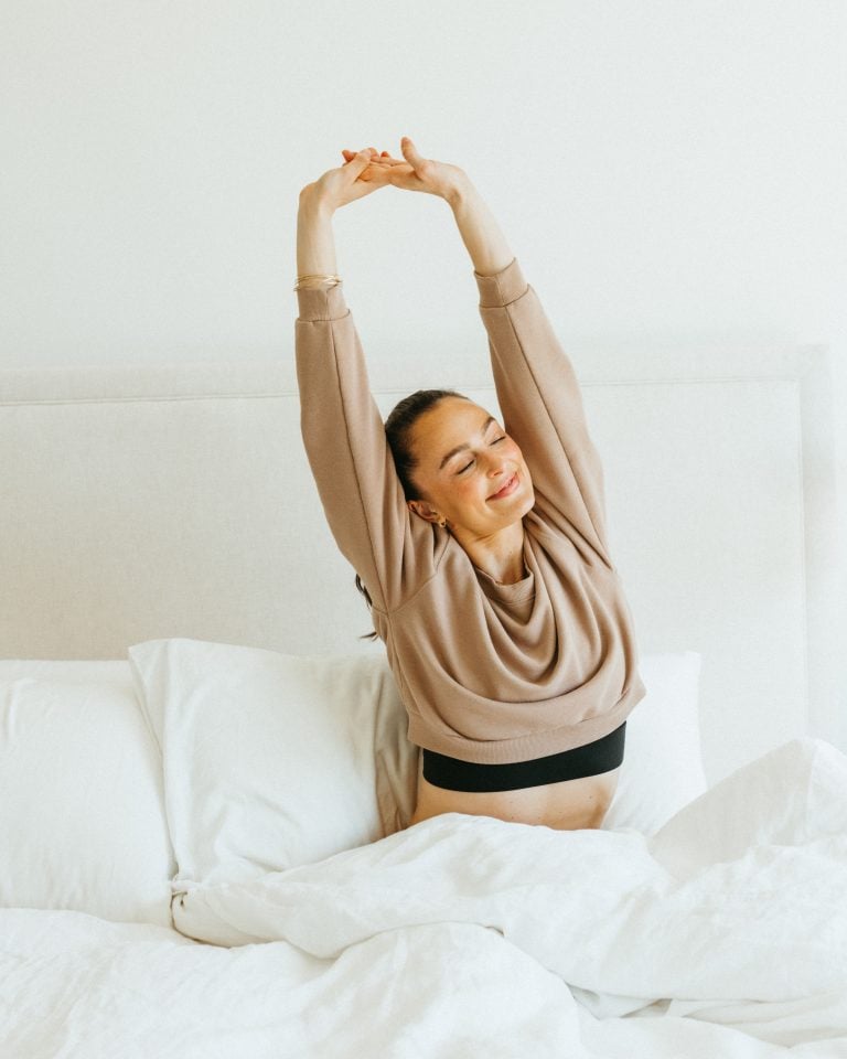 Megan Roup stretching in bed_best natural deodorants