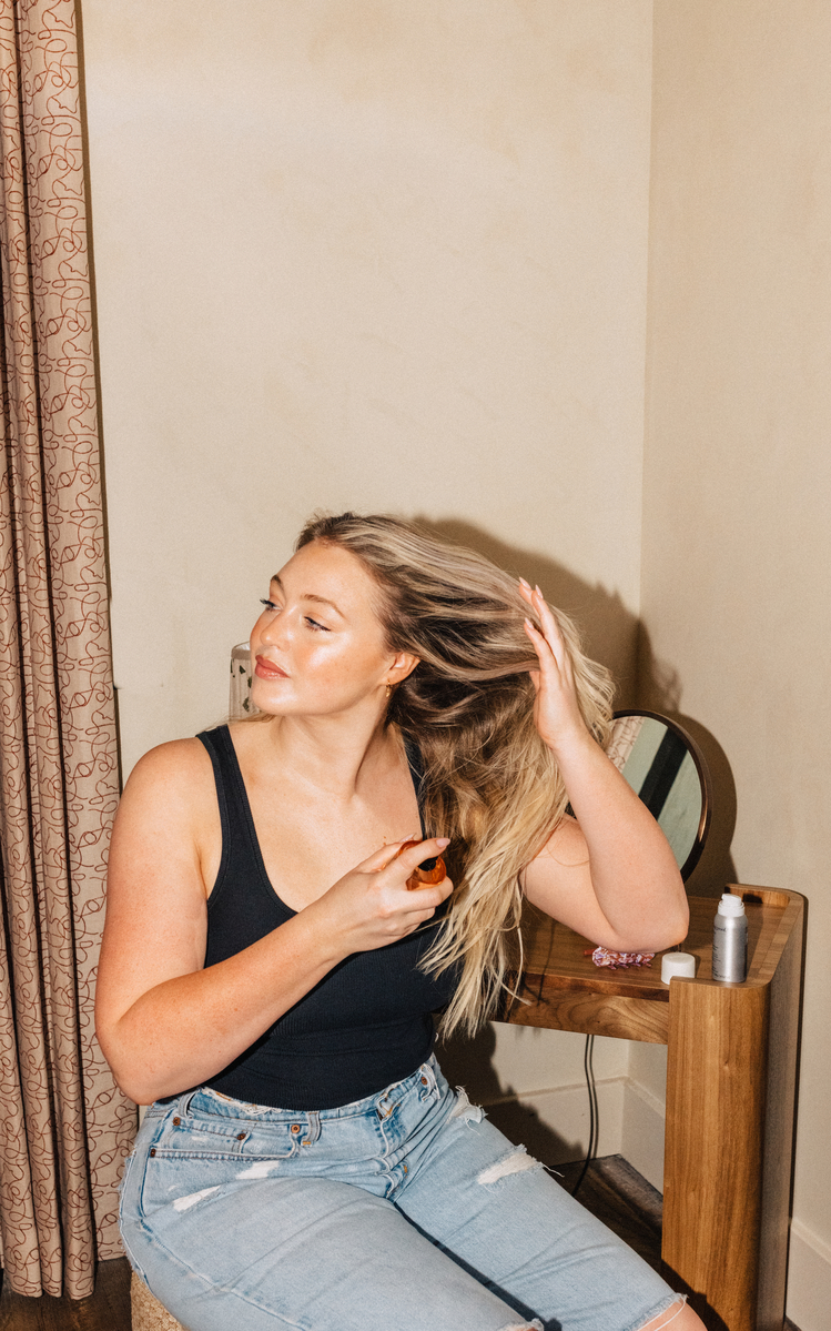 blonde woman using hair spray, best thickening hair products