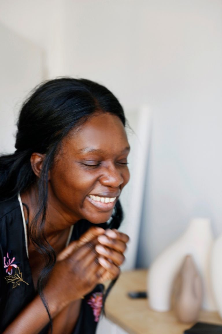 Black woman smiling.