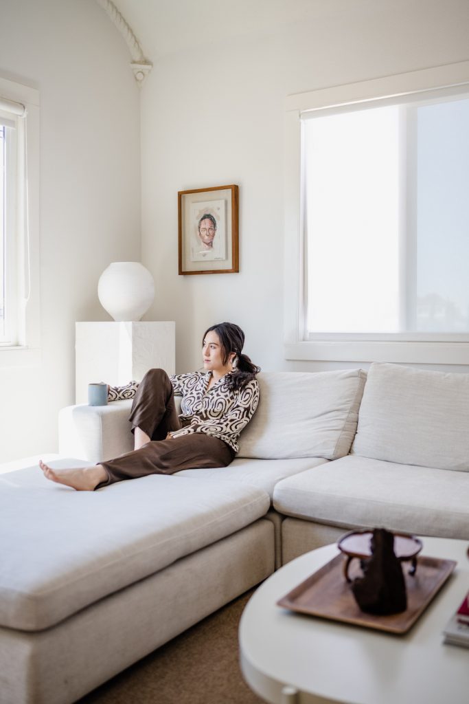 Diana Ryu sitting on couch in living room_how to detox your home