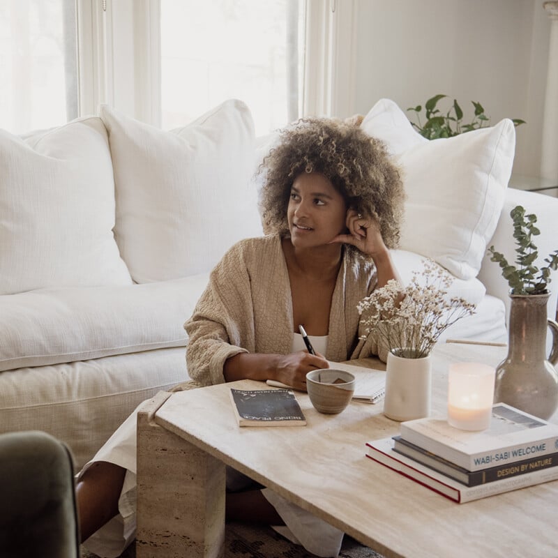 Black woman journaling.