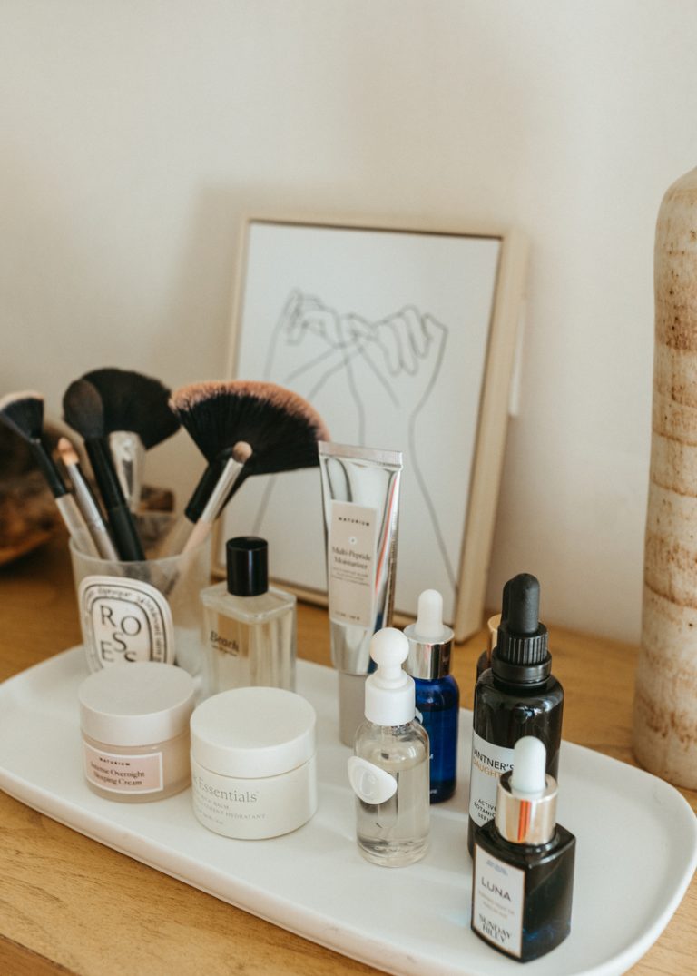 Skincare products on white tray.