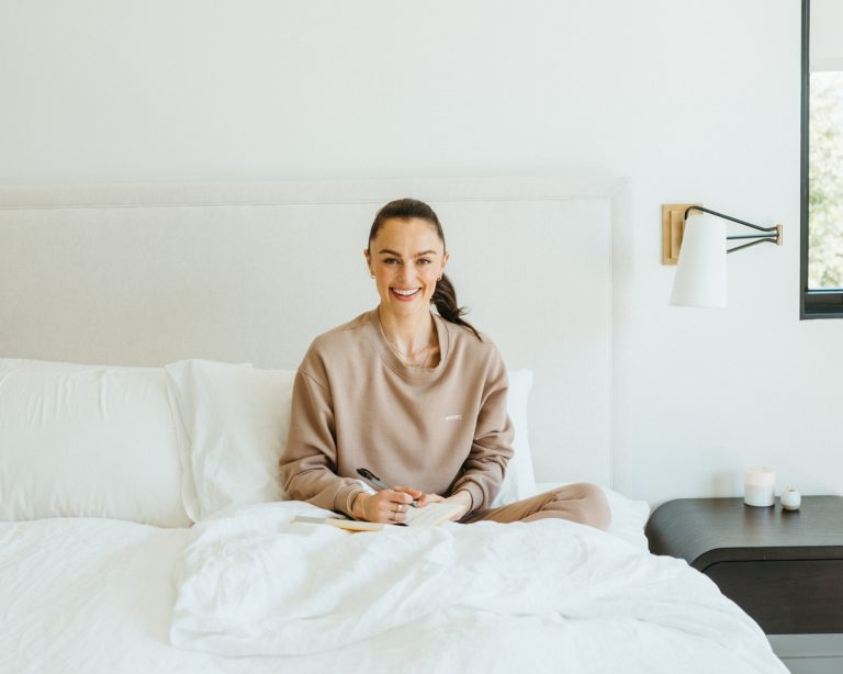 woman journaling in bed