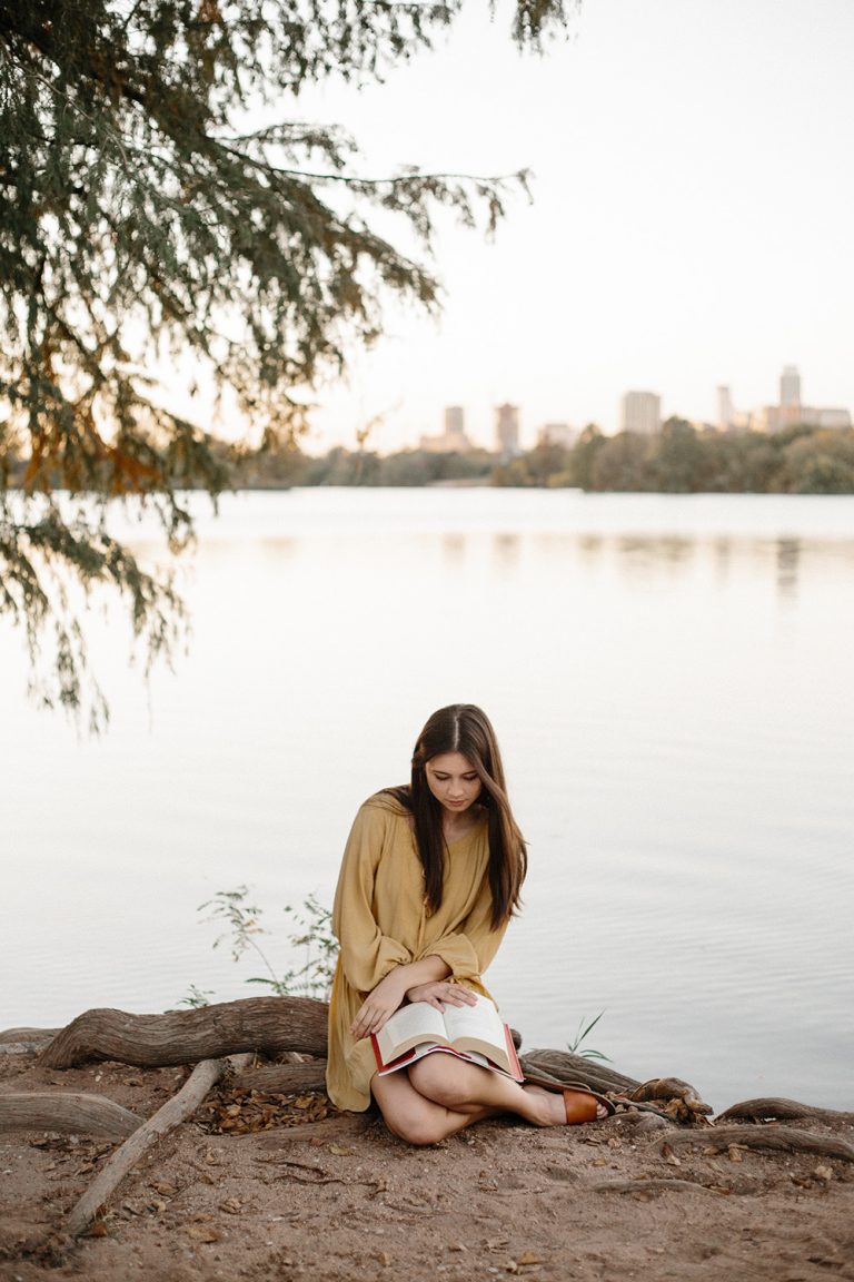 woman reading by river