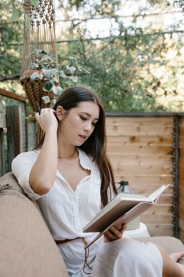 woman reading book outside