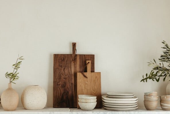 casa zuma stack of handmade wabi sabi plates and cutting board on open shelf