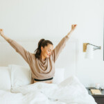 Woman waking up in bed.