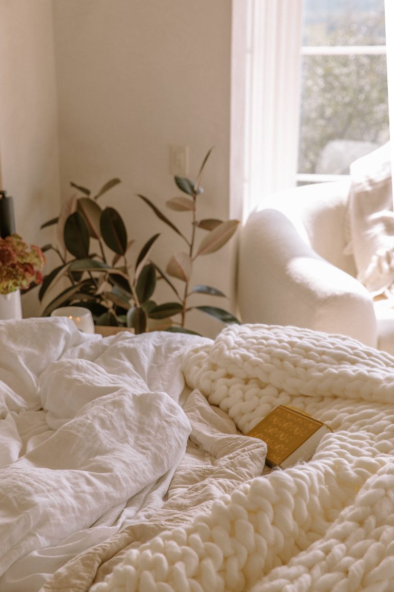 Touseled bed with chunky blankets_intimacy oils and lubricants