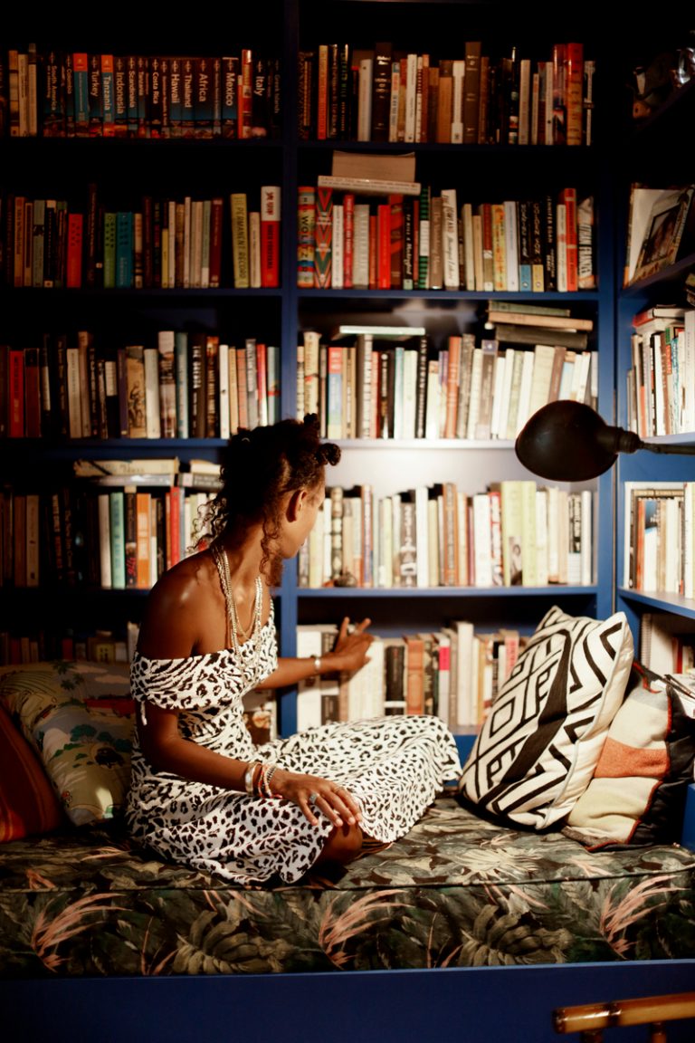 reaching for books on shelf