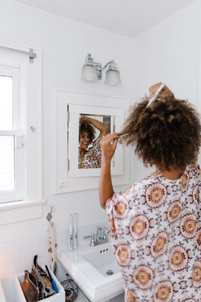 Riley Blanks Reed styling hair in mirror_low maintenance wash day