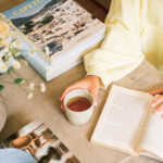 Woman drinking coffee reading.