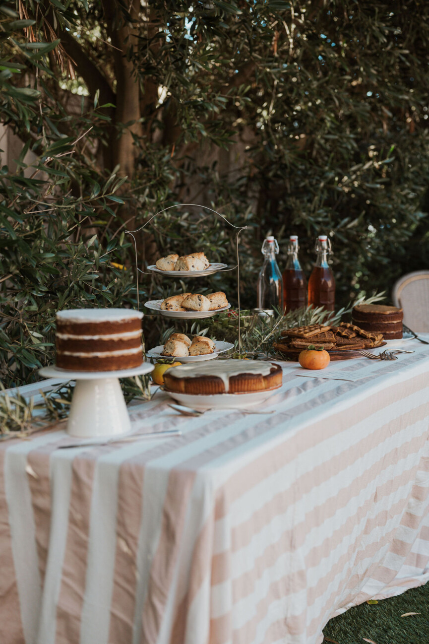 Laurel Gallucci, Sweet Laurel founder, Friendsgiving Brunch at Home in Los Angeles, table outside with cake, desserts