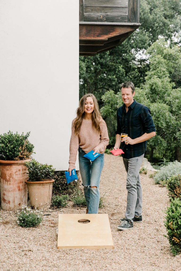 Camille Styles and Adam Moore playing corn hole_gifts for significant other