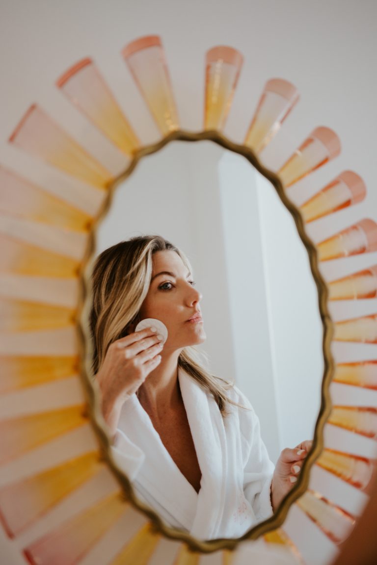 Inge Theron applying skincare in mirror