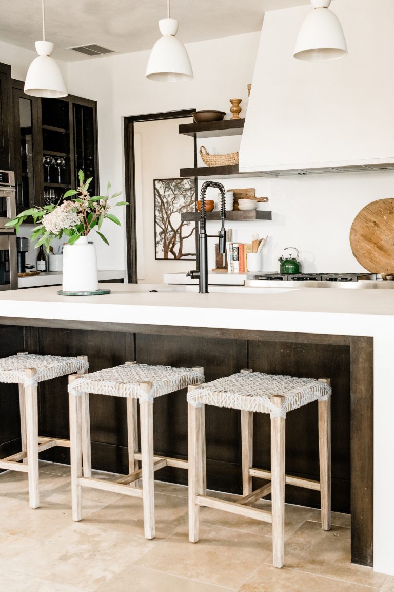 white kitchen with three island stools