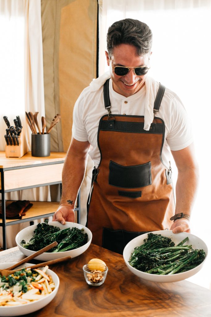 man serving broccoli rabe