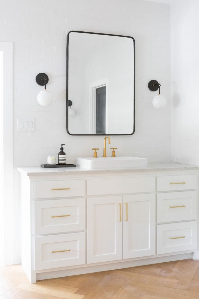 White bathroom with black vanity mirror