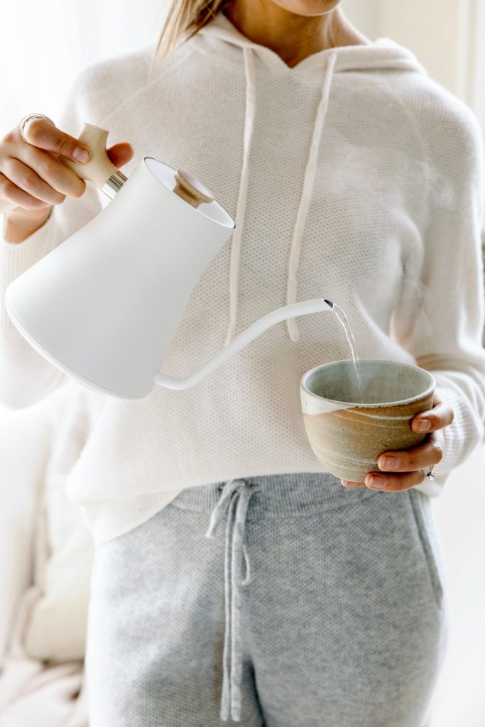 woman pouring tea how to digest food faster