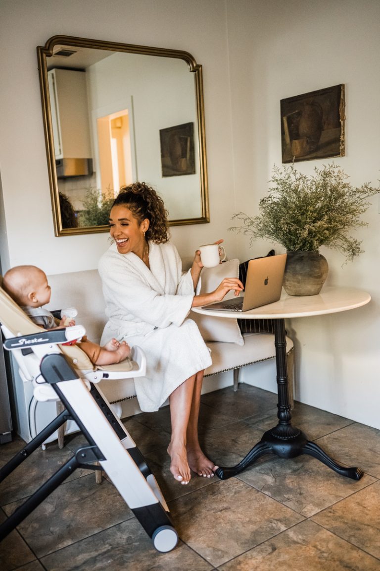 Simone Boyce working while smiling at her baby_overwhelmed at work