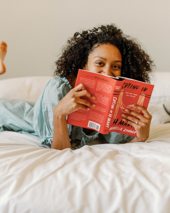 Woman reading bed.