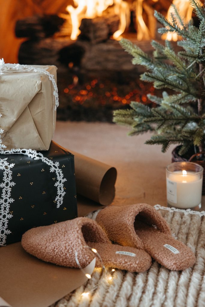 cozy Christmas fireplace presents slippers best classic holiday movies