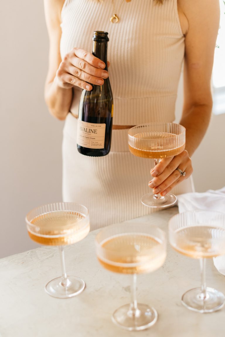 Camille Styles pouring champagne