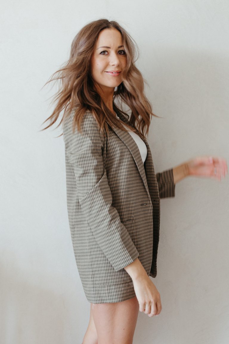 Camille Styles wearing plaid blazer