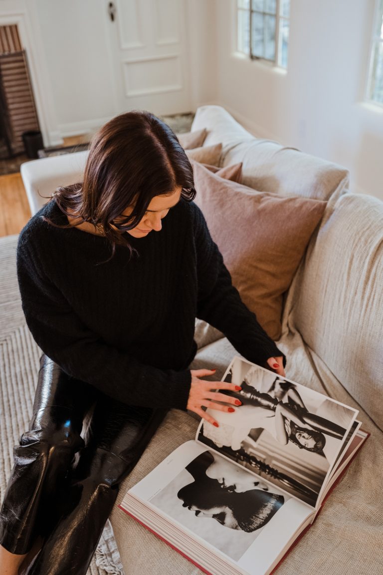 woman looking through style book 2023 beauty trend predictions