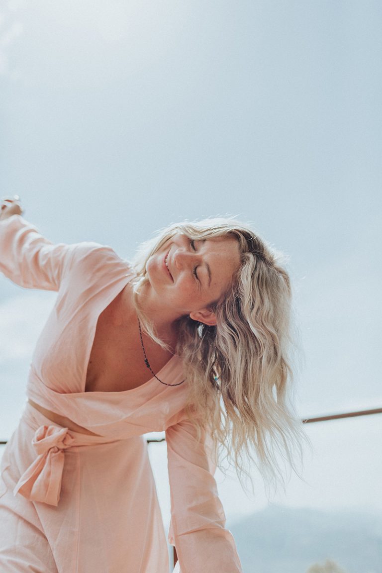 Personal growth of a woman dancing in a pink dress