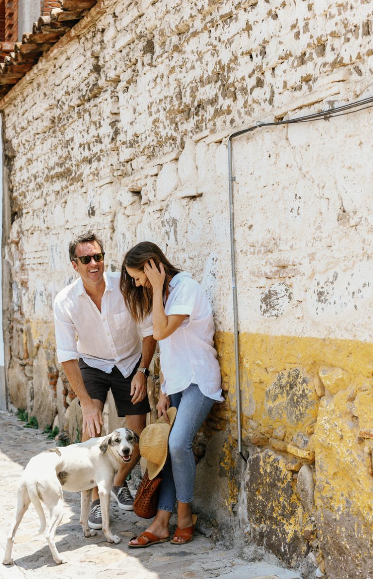 Woman and man petting a dog on the street New Year's intentions