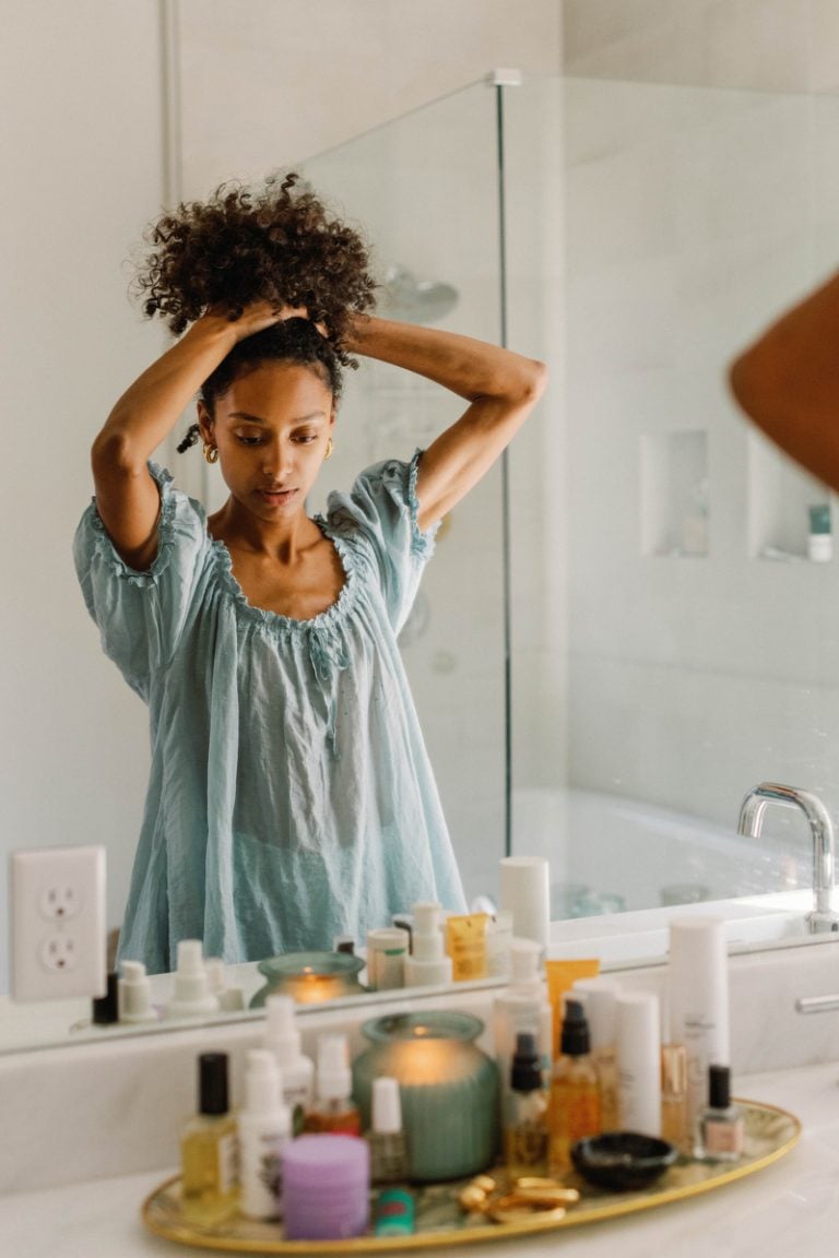 woman putting up hair wellness gifts