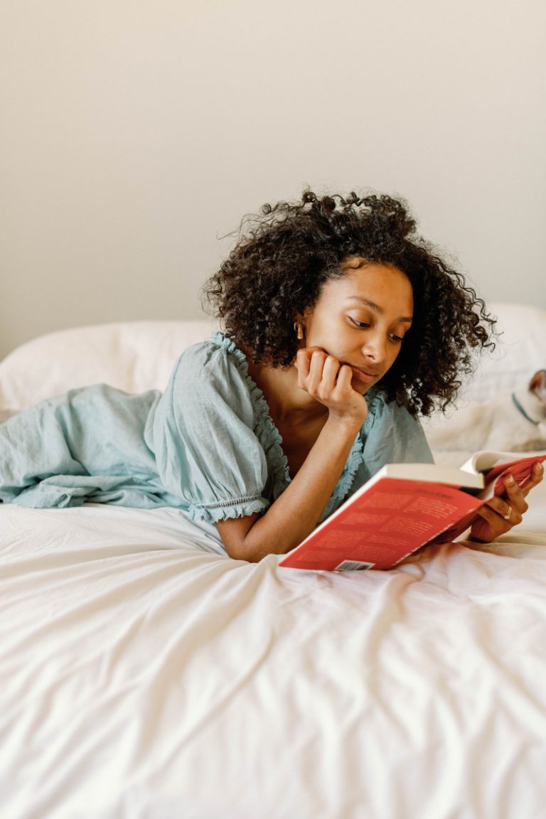 woman reading in bed winter hair care tips
