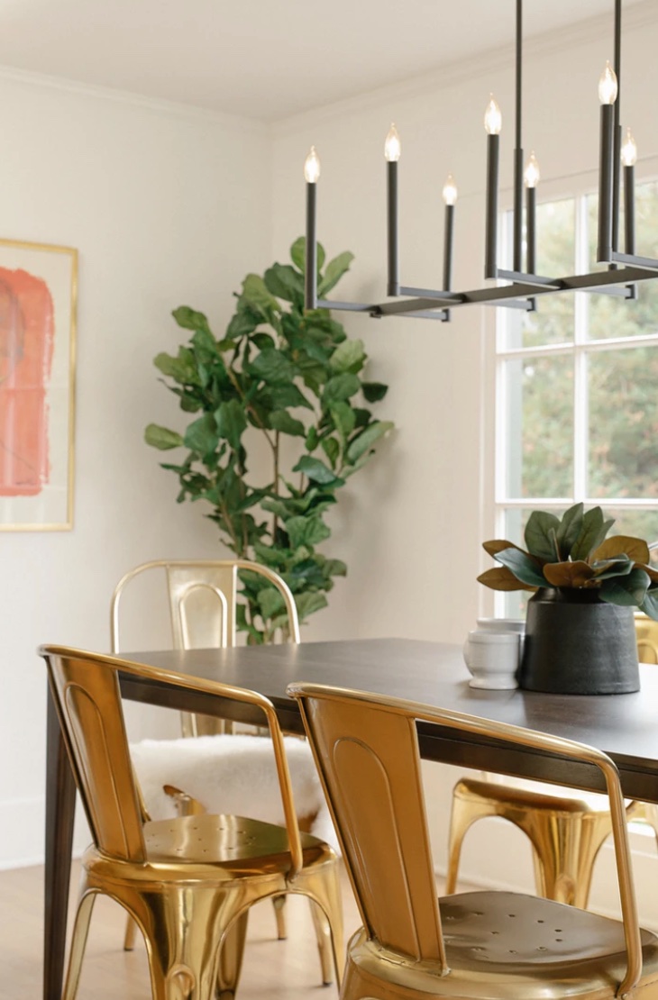 Small space dining room with gold chairs.