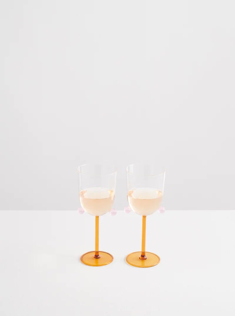 https://camillestyles.com/wp-content/uploads/2023/01/Maison-Balzac-2-Pompom-Wine-Glasses-Miele-and-Pink-130.jpg