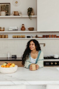 Radhi Devlukia-Shetty drinking tea in kitchen.