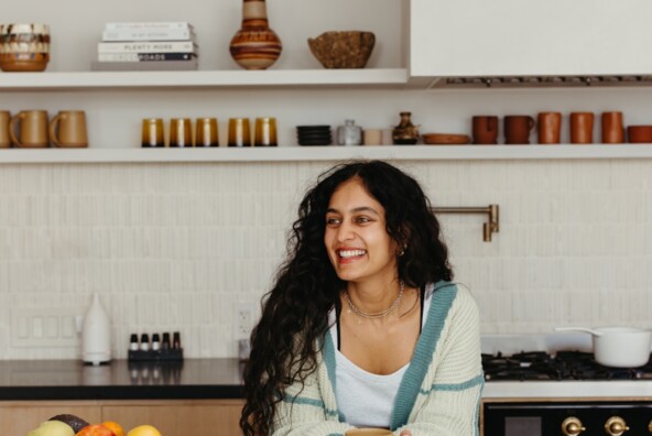 Radhi Devlukia-Shetty drinking tea in kitchen.