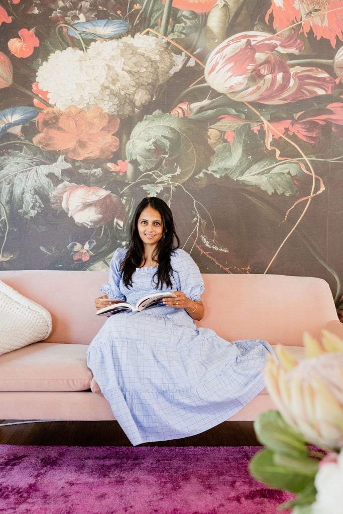 Aishwarya Iyer reads on the couch