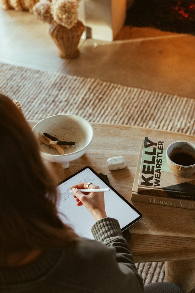 Woman journaling on ipad.