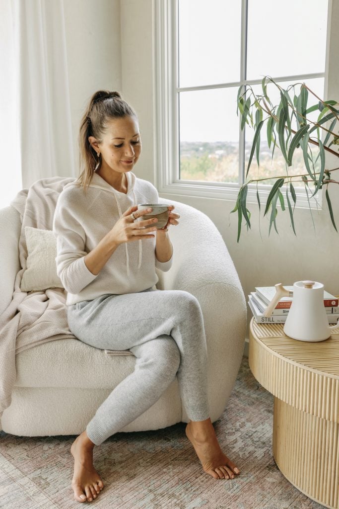 woman wearing loungewear drinking tea energy drainers