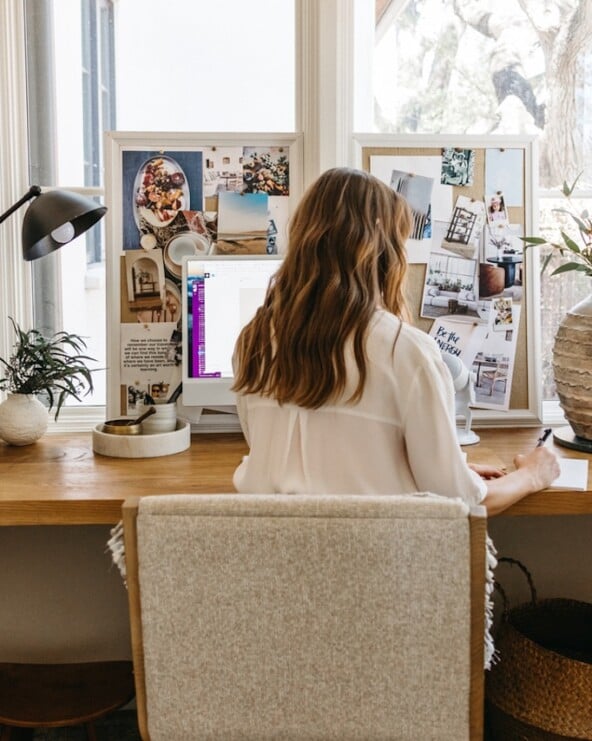 Camille Styles writing at desk