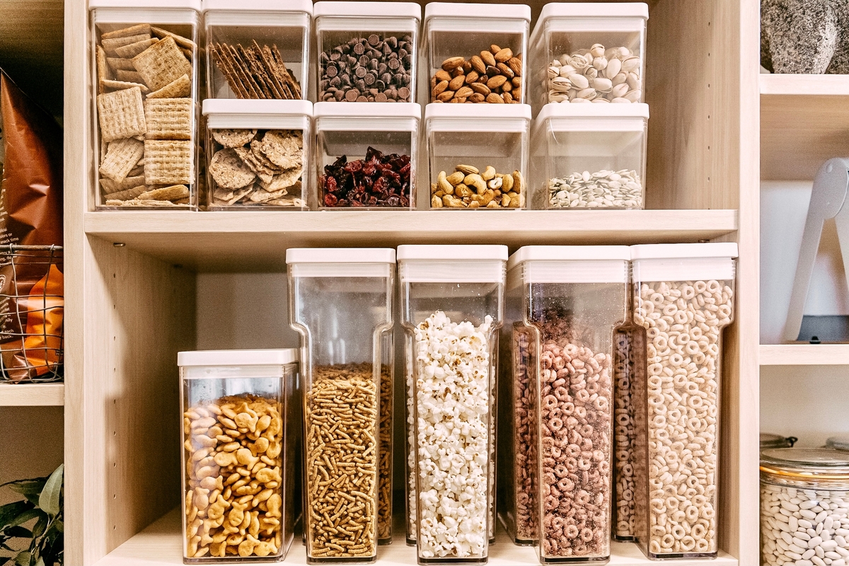 organized pantry with food in plastic bins