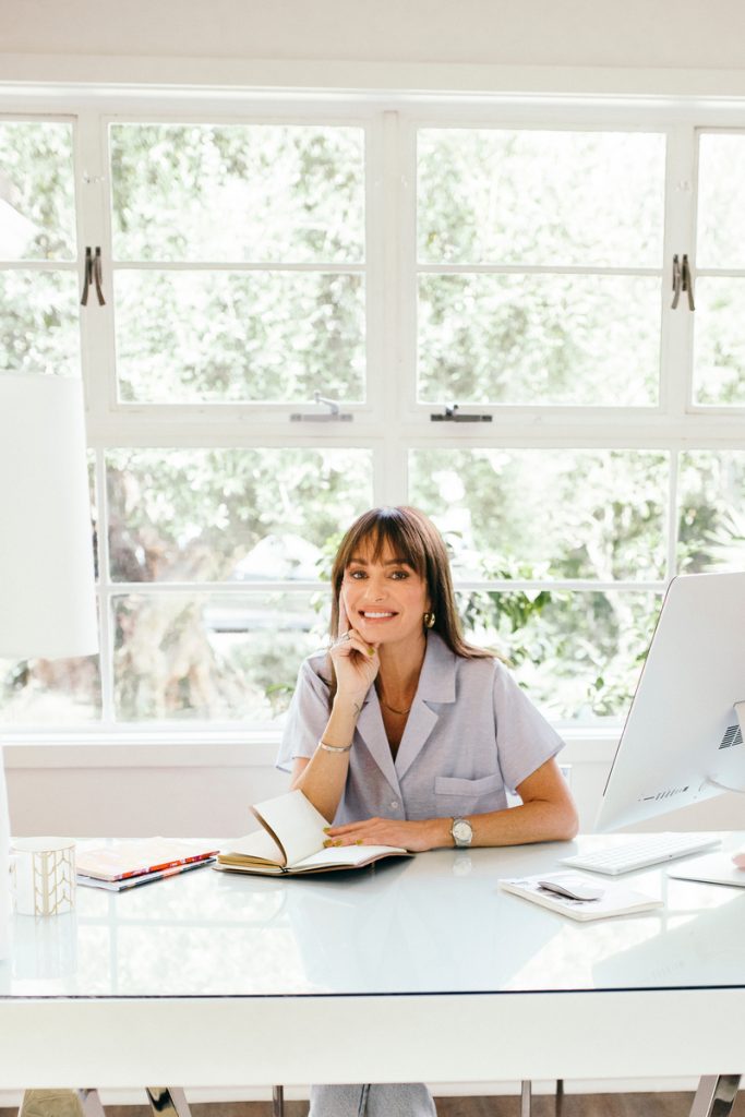 woman smiling reading at desk fear of failure