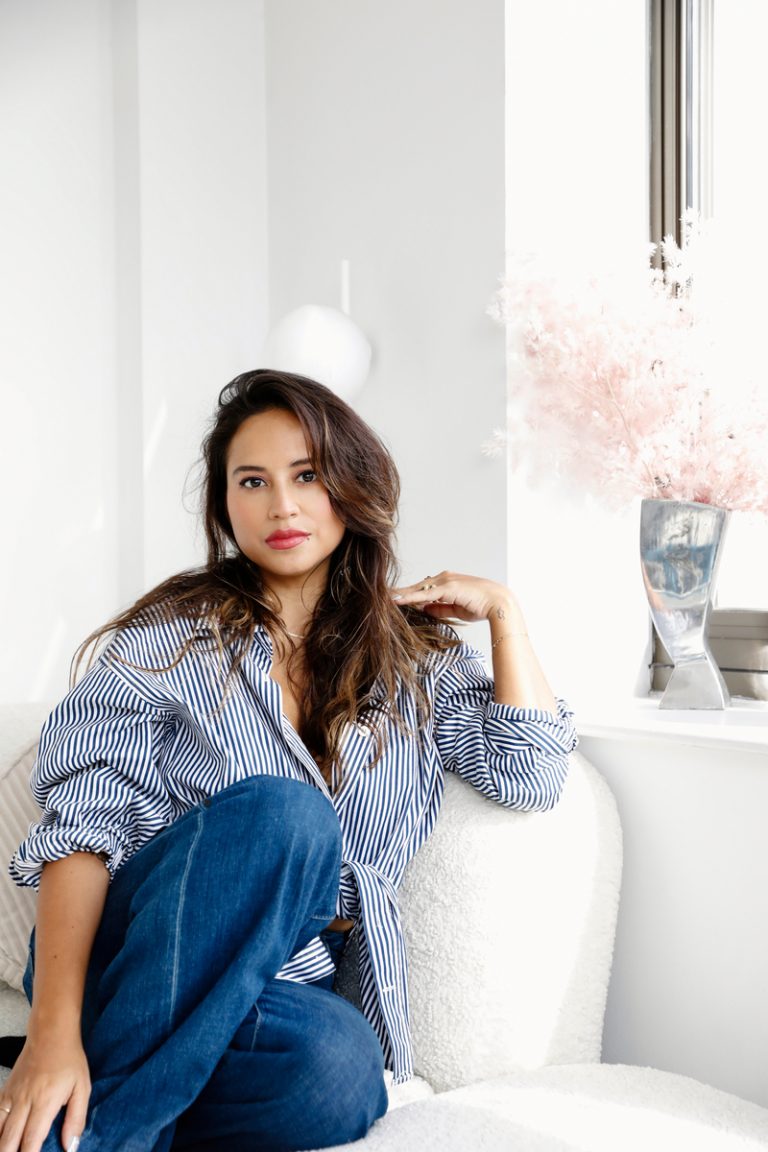 woman with long hair sitting on couch best hair styling products