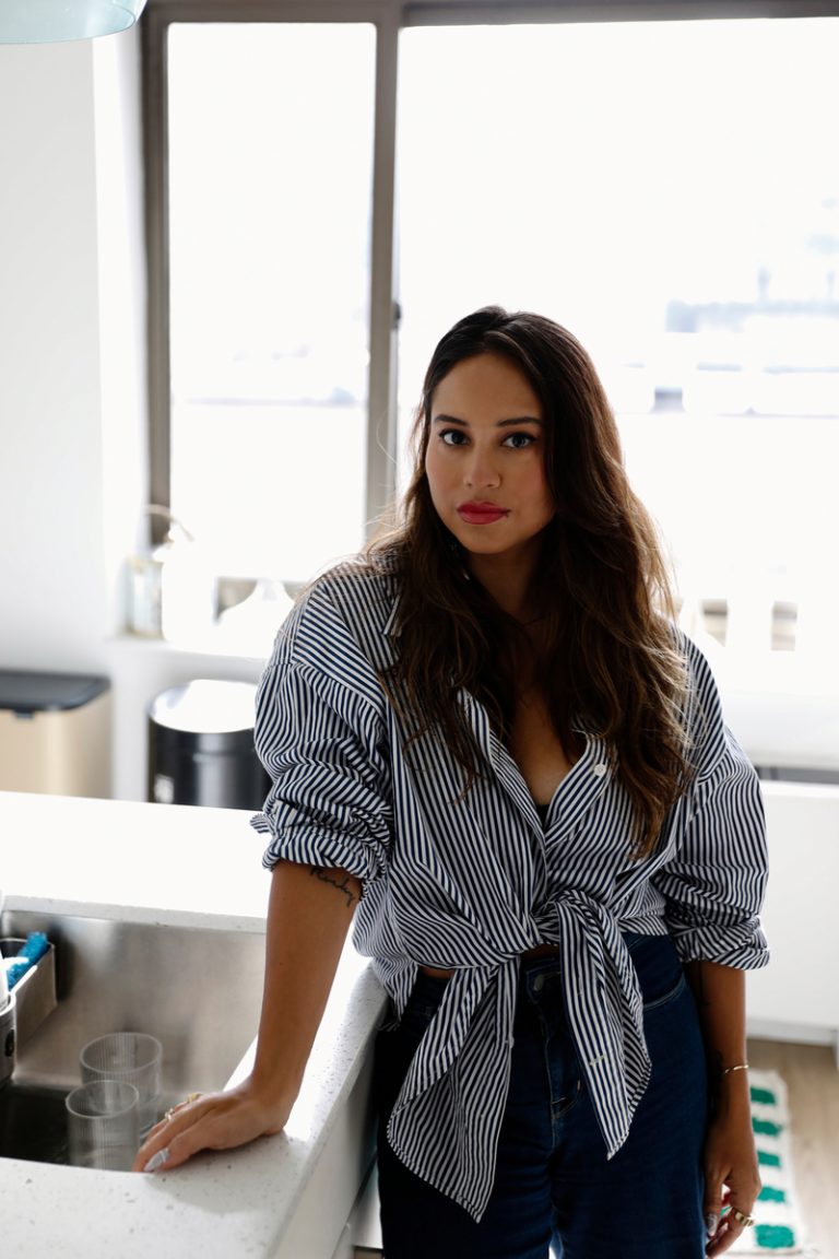 brunette woman wearing blue and white striped button up