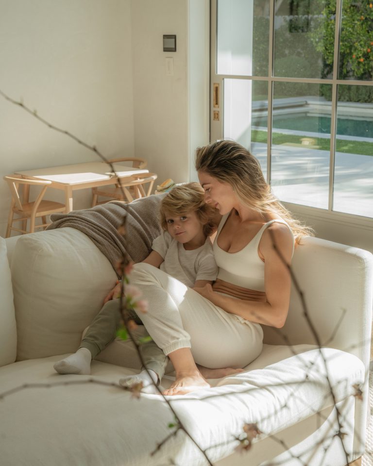 blonde woman son cuddling on couch