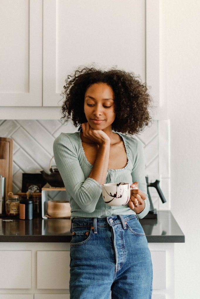 Woman drinking coffee in the kitchen